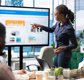 Advisory board members and team leaders gathering to review project outcomes, discuss resource allocation to ensure objectives achievement. Diverse business associates in a meeting.