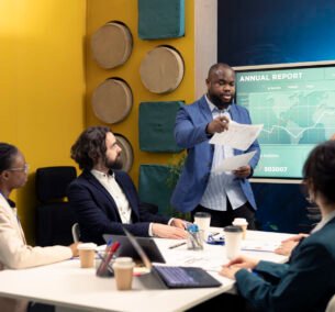 Corporate employees reviewing transactional info to improve customer satisfaction, expanding on the market. General director and his team making critical decisions regarding activity development.