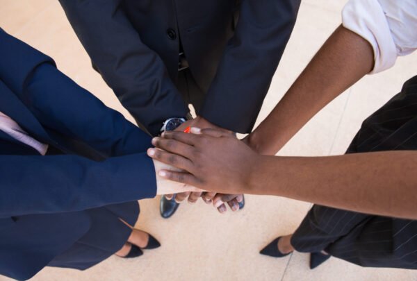 Teamwork, support or friendship gesture. Stack of hands of mix raced business professionals. United team concept